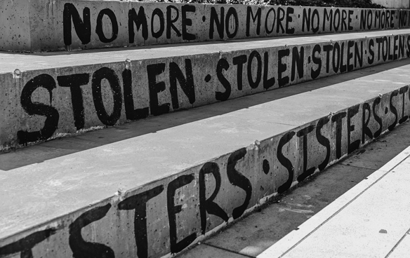 No More Stolen Sisters written in black paint on concrete steps