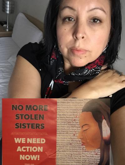 Rose Quilt holding MMIW poster: No More Stolen Sisters - We Need Action Now
