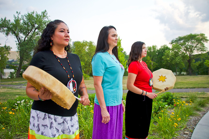 Image of three MIWSAC staff holding drums. 