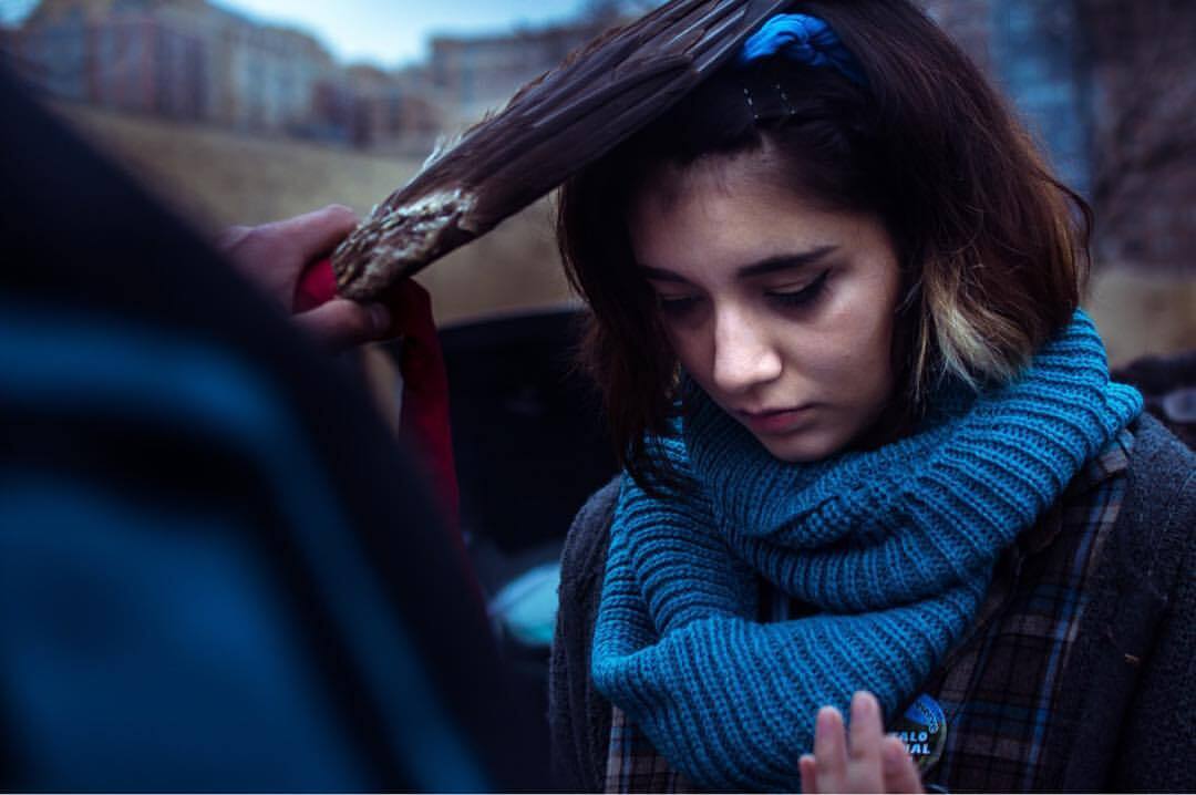 "Olivia Ramirez at the 2017 Women’s March in Washington, D.C. being smudged off by Casey Camp. (Photo courtesy of Olivia Ramirez and Olivia Gray.)."