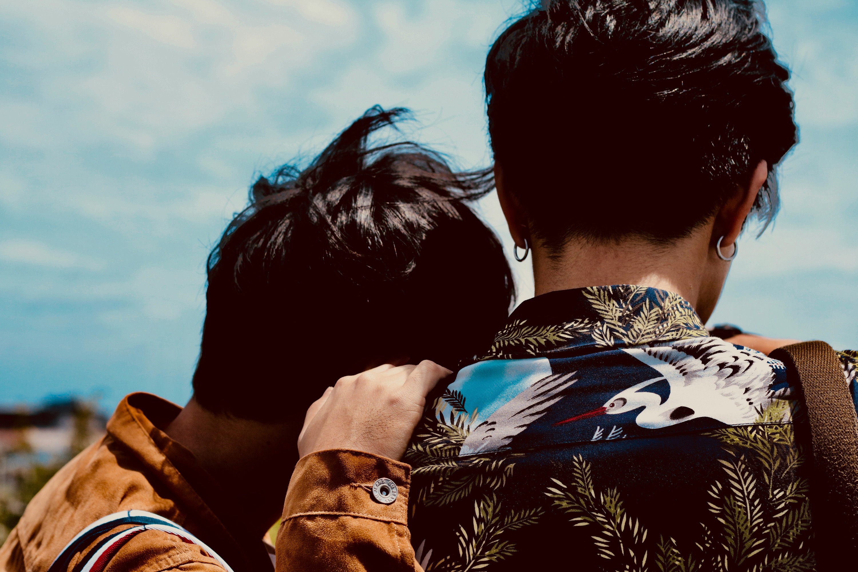 "Photo (from behind) of a couple looking off into the distance."